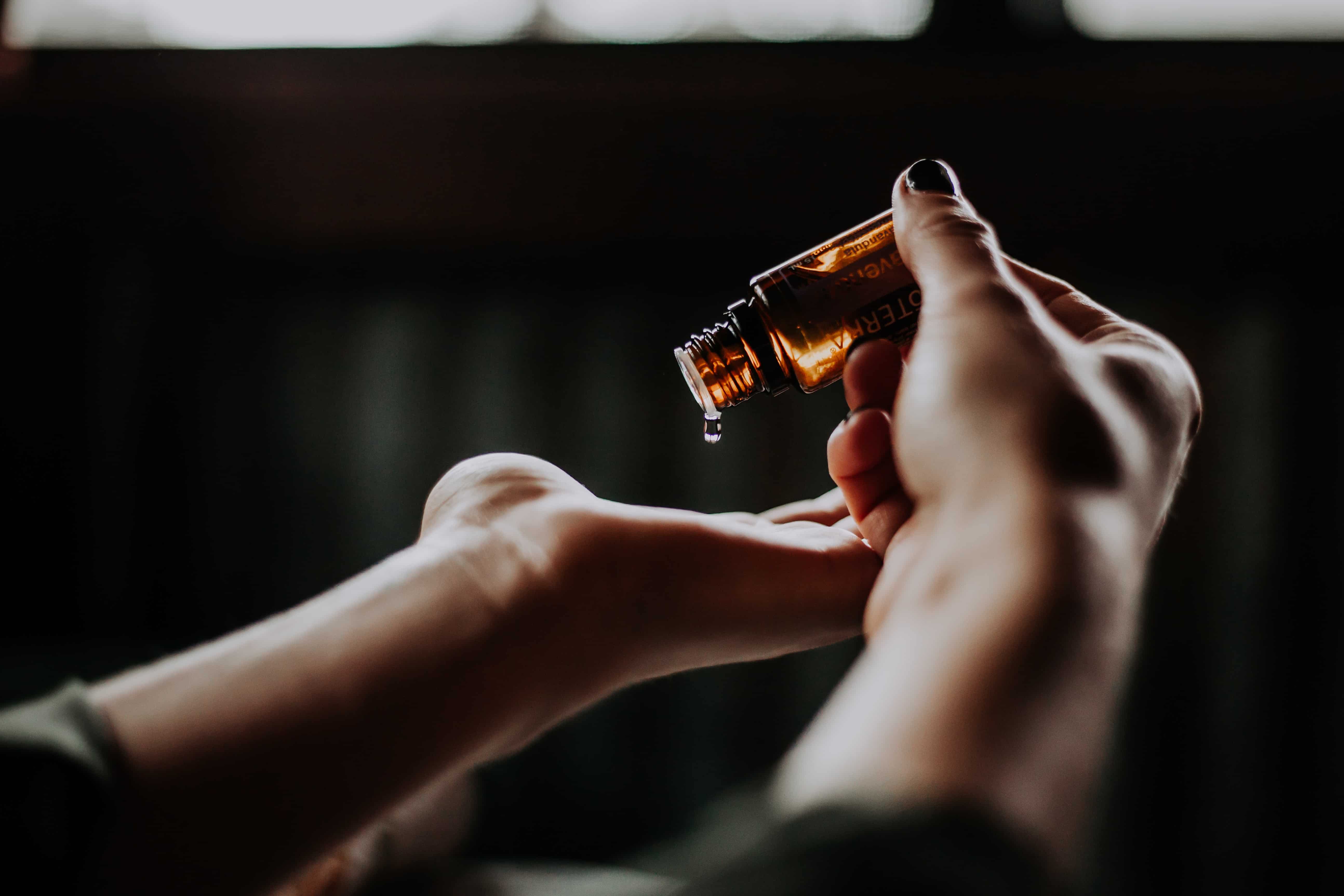 woman applying non-toxic essential oil